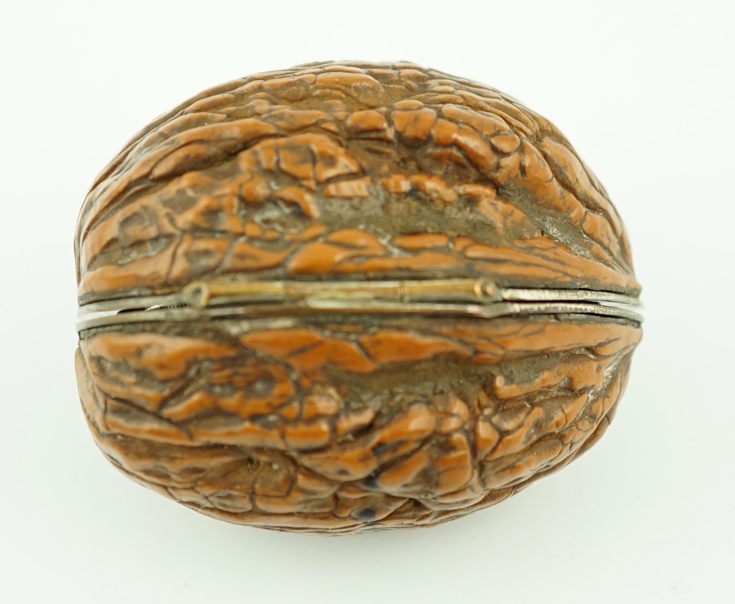 A 19th century French novelty etui case, modelled as a walnut, containing six silver or silver mounted implements